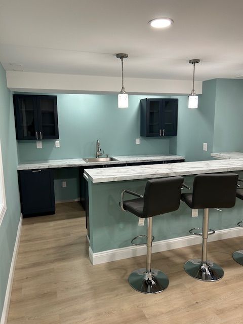 A kitchen with a long counter and two bar stools