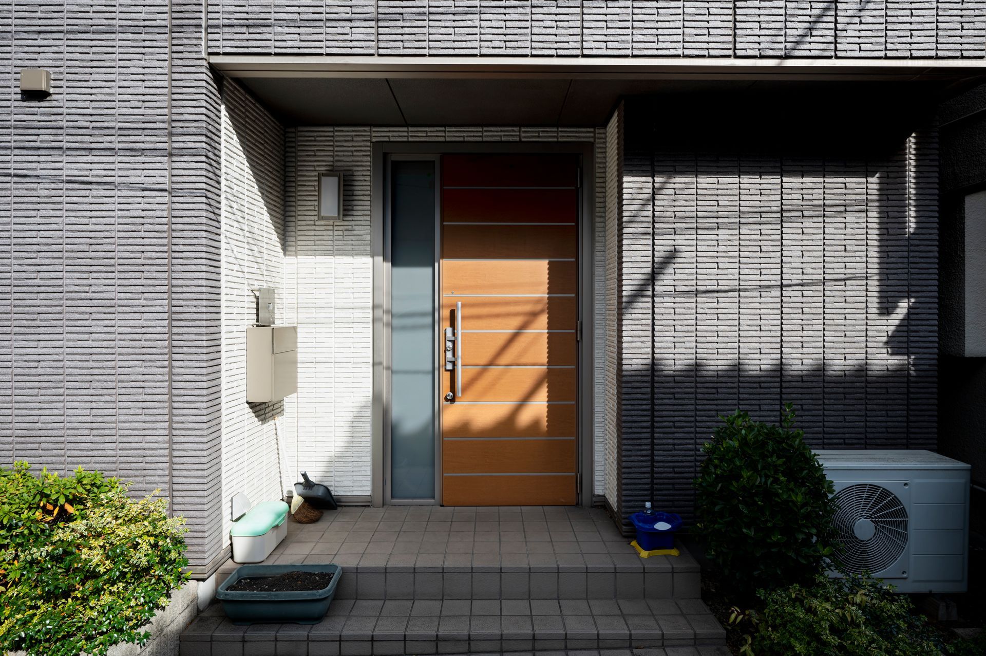A brick building with a wooden door and steps