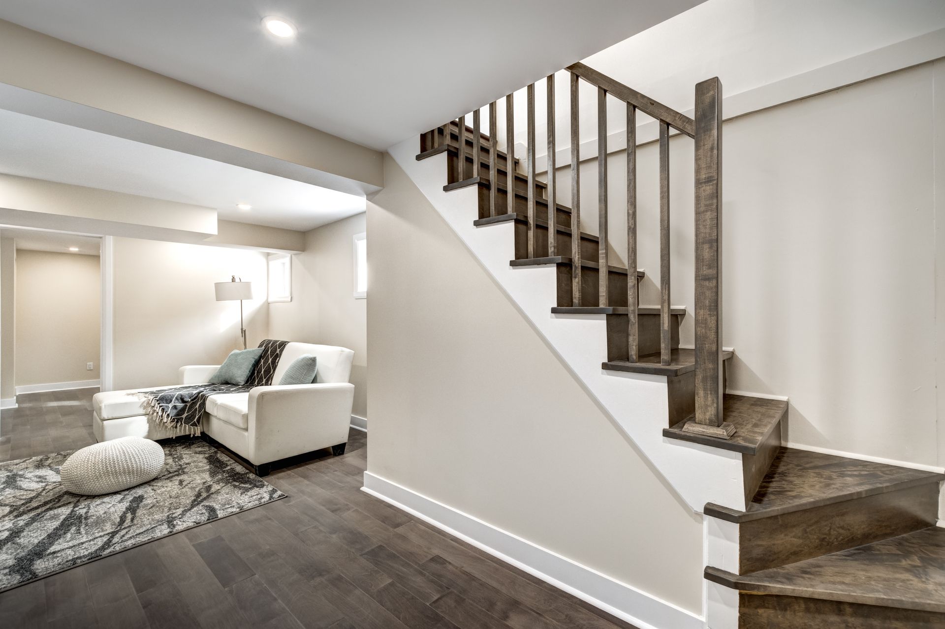 A living room with stairs leading up to the second floor