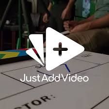 A white triangle with a plus sign on it is sitting on top of a table.