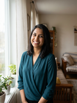 A man is standing on a city street holding a cup of coffee.