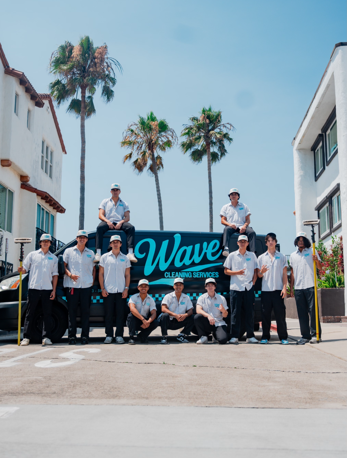 Wave Cleaning Services team posing in front of a van on a sunny day.