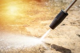 Pressure washer cleaning a concrete surface.