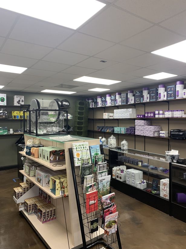 Learn resources and image of shelves at Growpher's Storefront including a large manually operated trimming machine