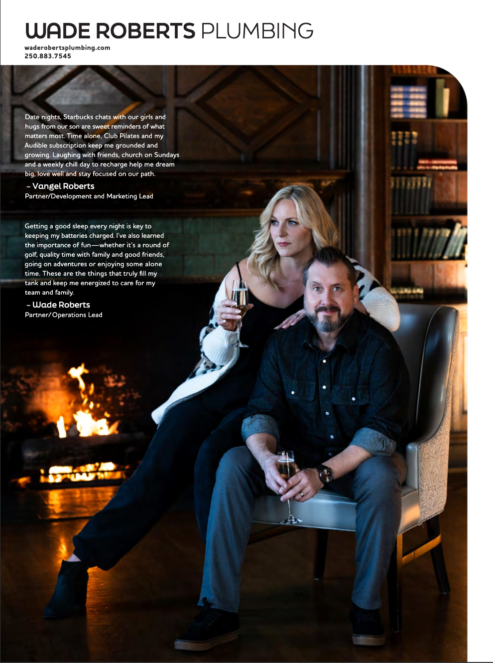 A man and a woman are sitting in a chair in front of a fireplace.
