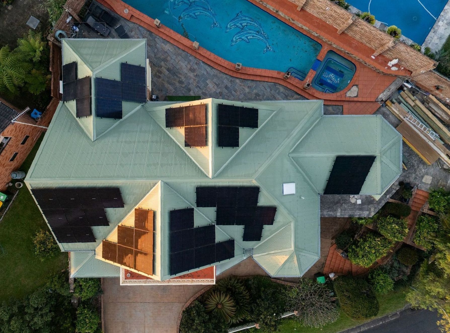 Aerial shot of a new green house roof with lots of solar panels — GT Metal Roofing Solutions in Wollongong, NSW