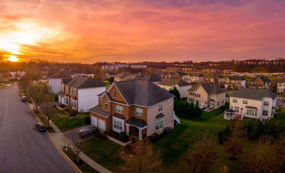 An aerial view of a residential neighborhood at sunset.