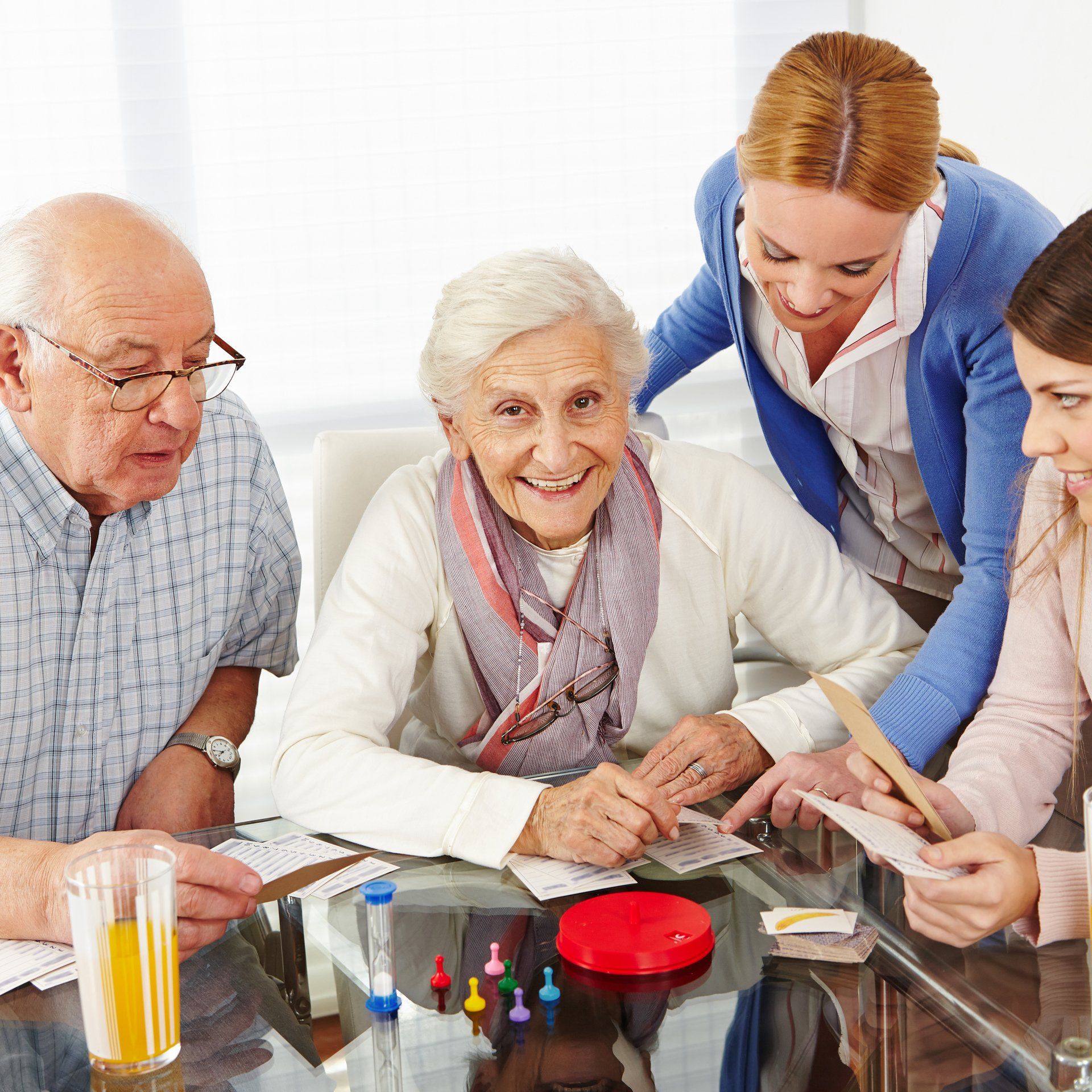 A group of people are sitting around a table playing a game
