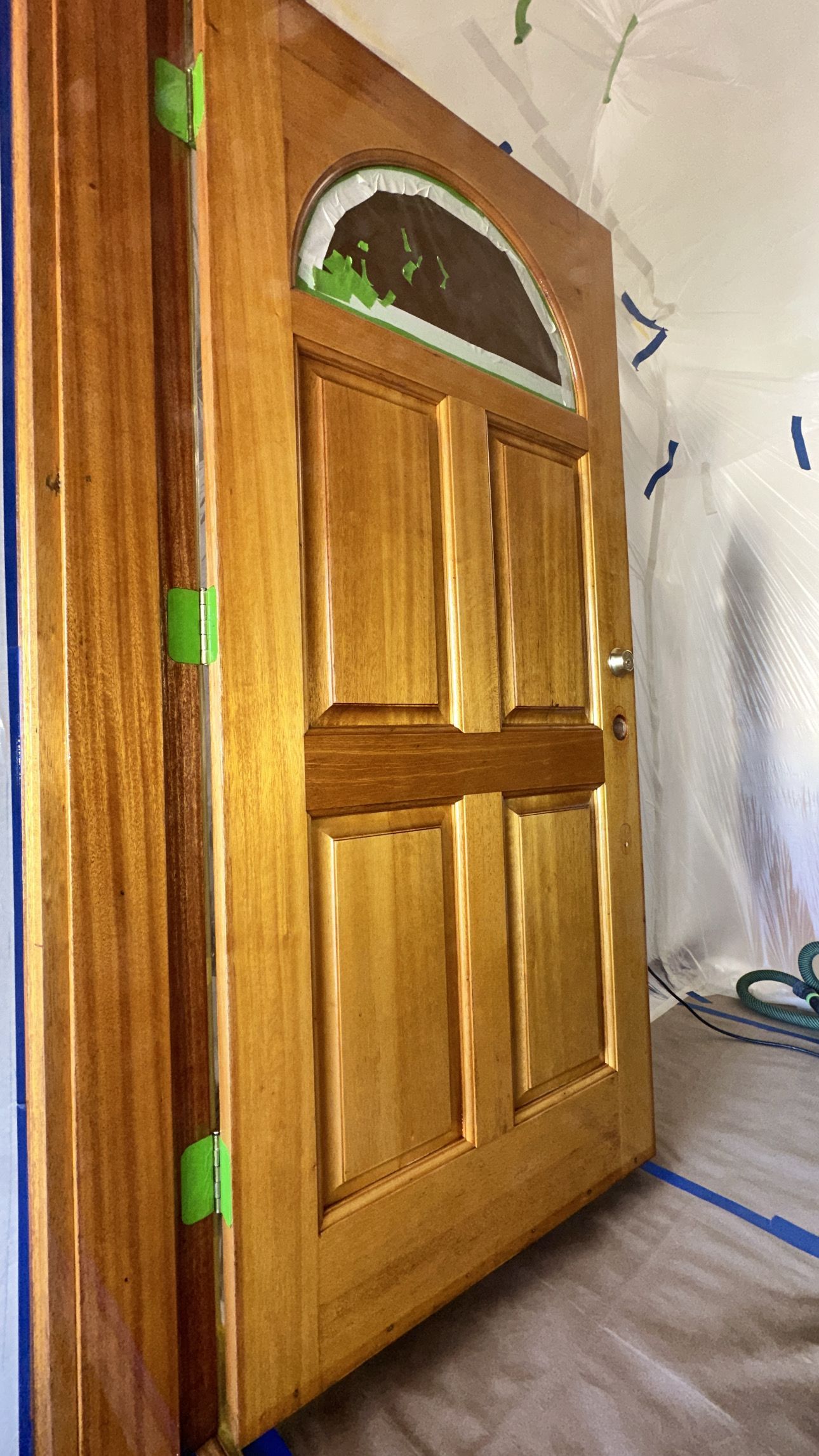 Gray cabinets with white countertops, open shelves, and track lighting in a kitchen area with hardwood floors.