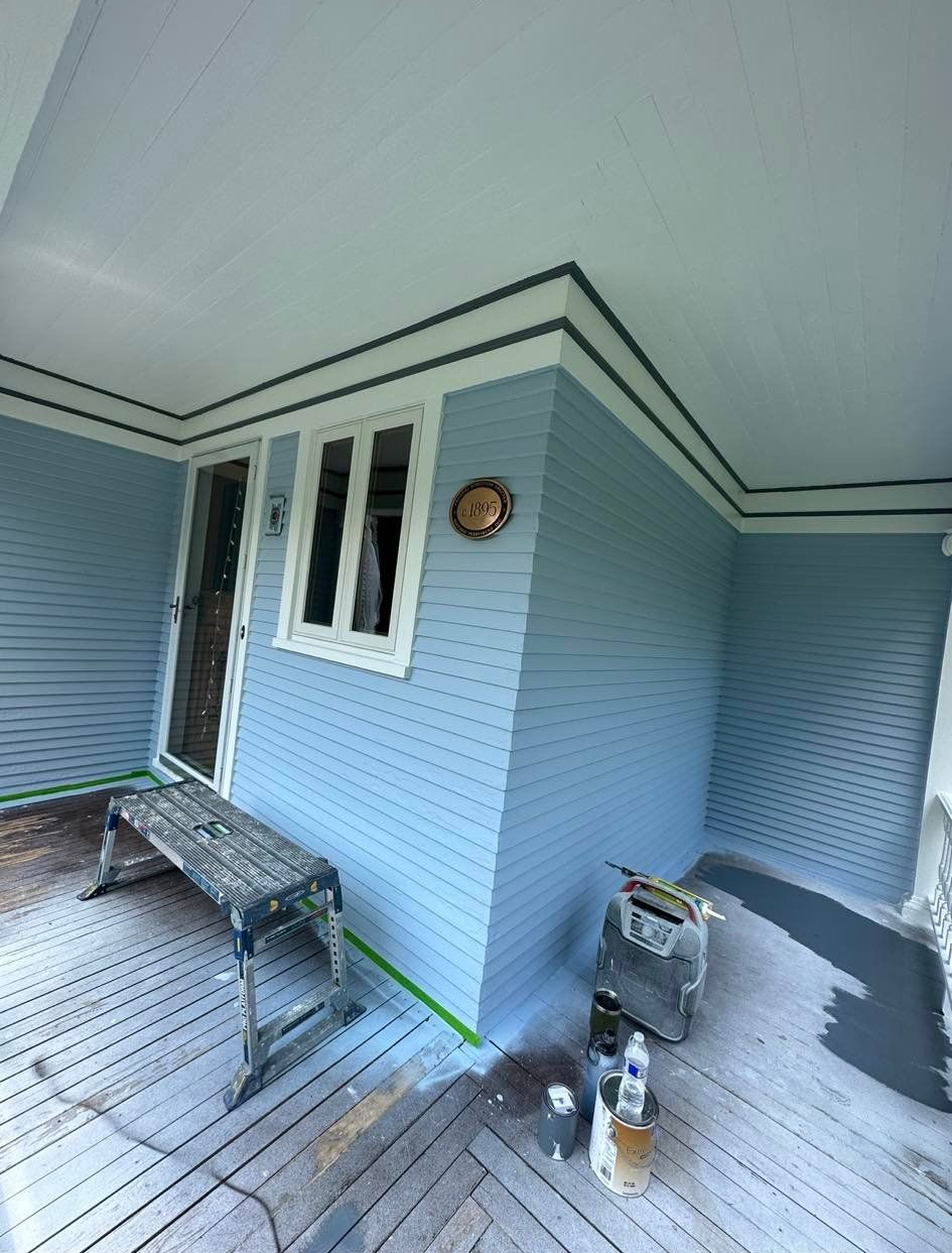 Blue house exterior with white trim, window, and porch. Includes tools.