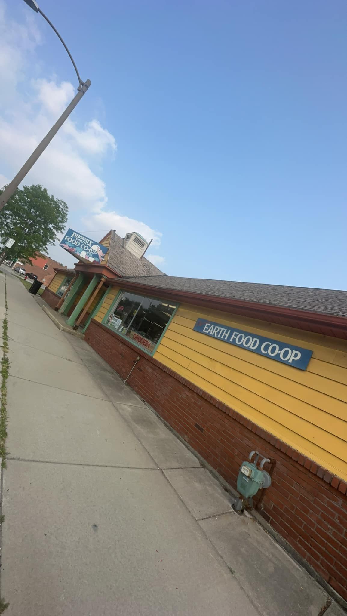 A brightly colored building on a steep street, labeled 