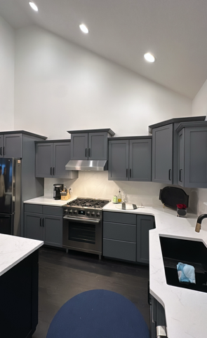 White kitchen cabinets with silver handles.