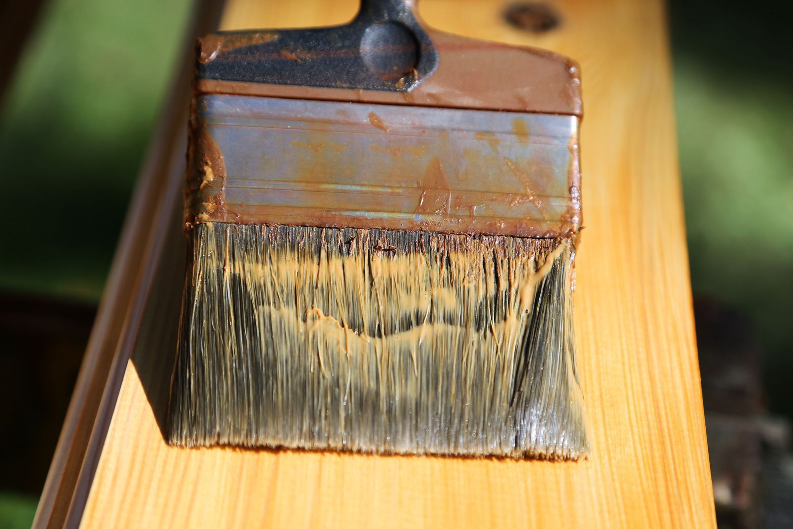 Staircase leading up with gray steps. Light and shadows are cast on the right wall. A door is at the top.