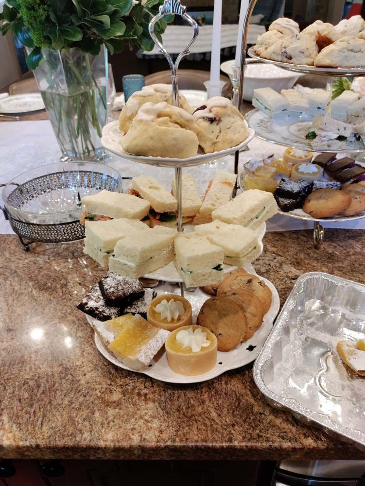 A table topped with a variety of pastries and sandwiches.