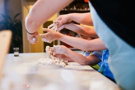 A group of children are playing with flour on a table.