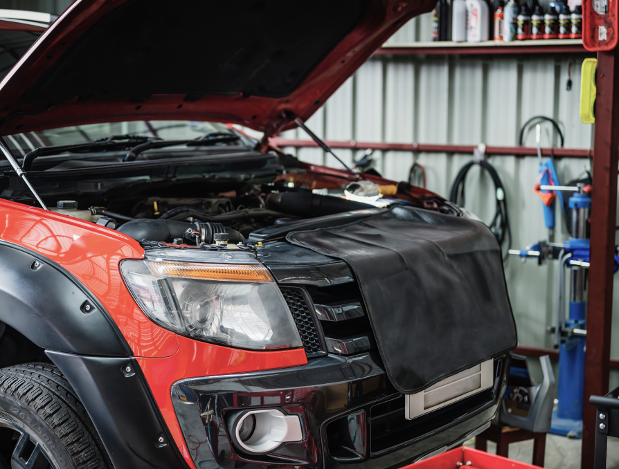 Red car in garage with hood up | Key Diesel and Auto Service