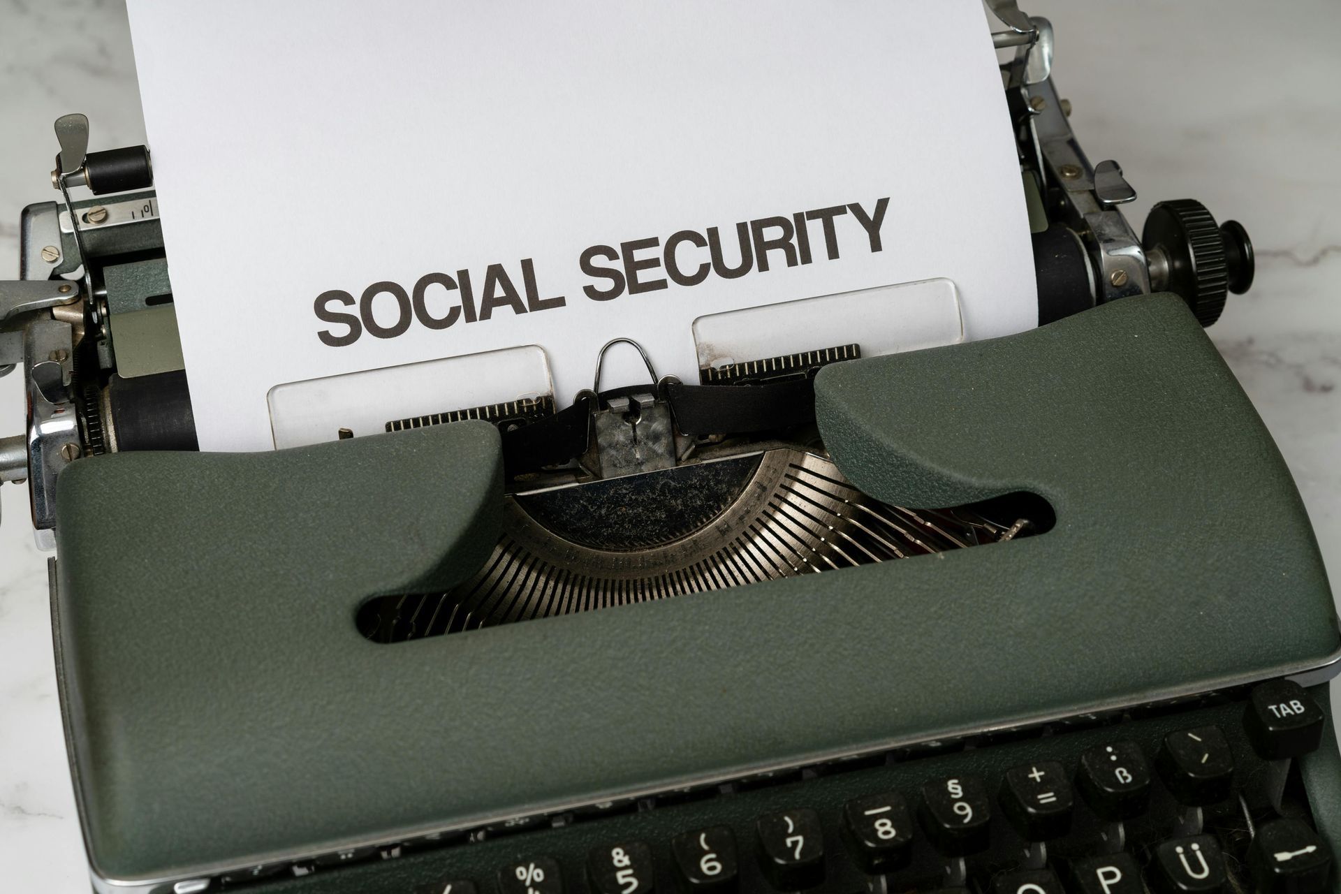 A typewriter with a piece of paper that says social security