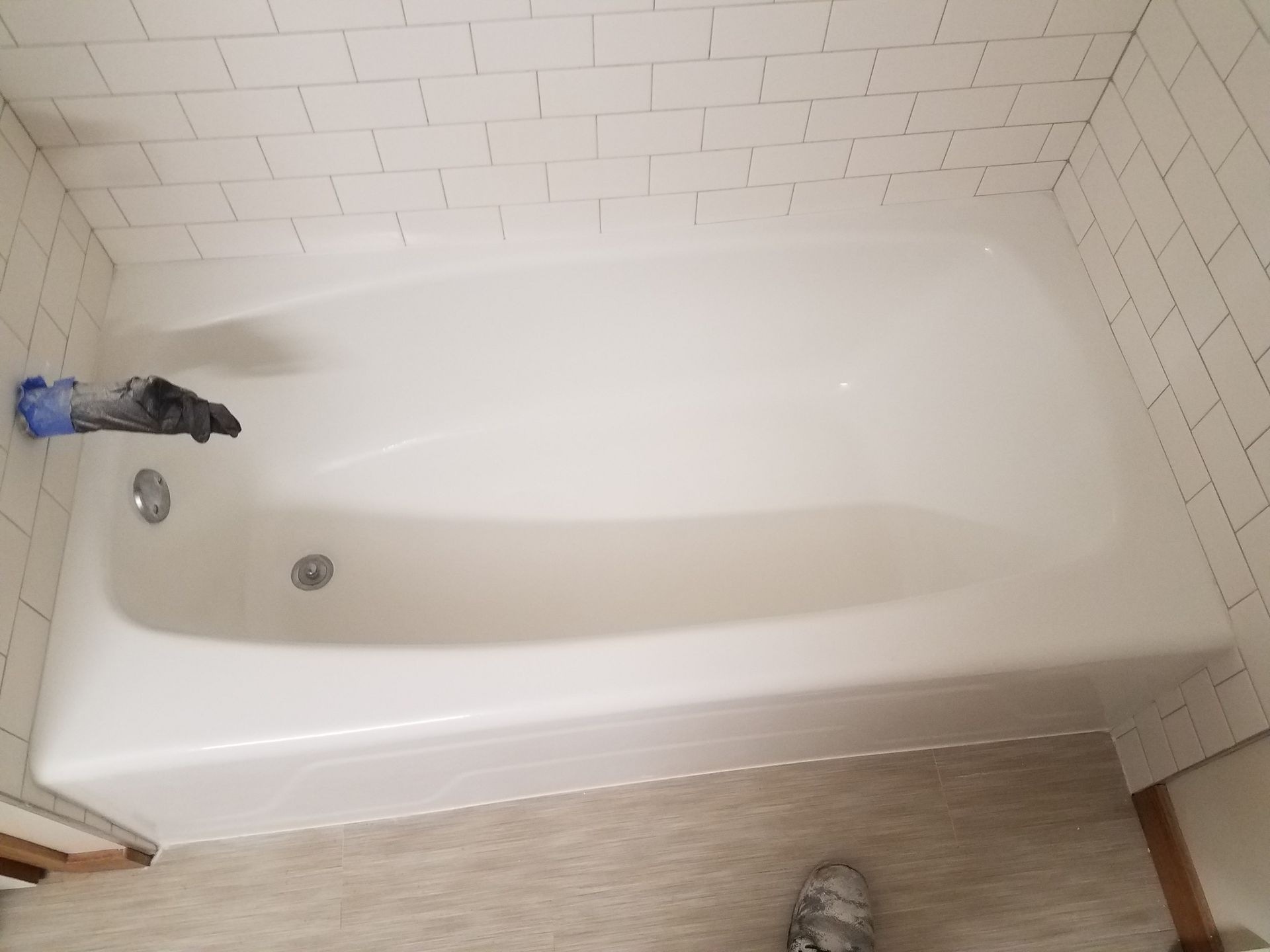 White bathtub with faucet and subway tile walls.