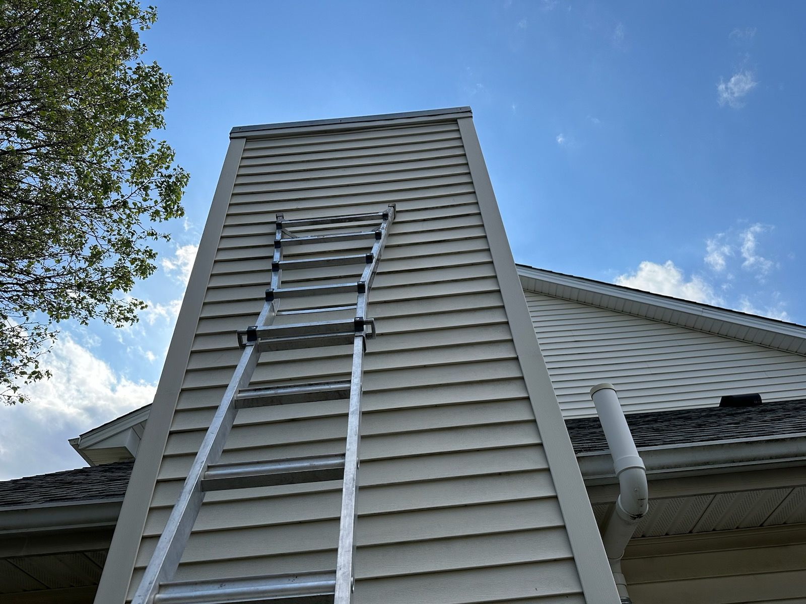 A ladder is leaning against the side of a house | Champaign, IL | Unity Construction