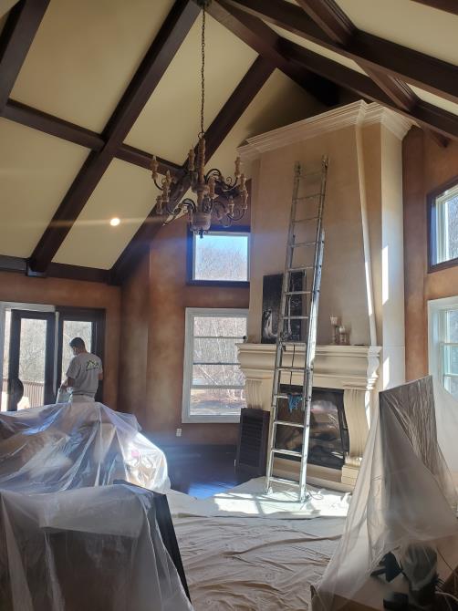 A living room with a ladder in the middle of it