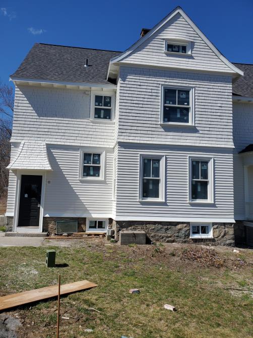 A large white house with a gray roof
