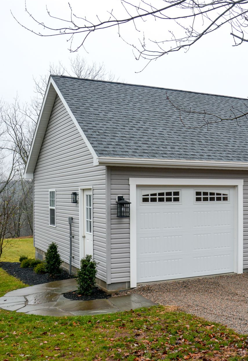 An Amish-built garage with a copper cupola on top of it