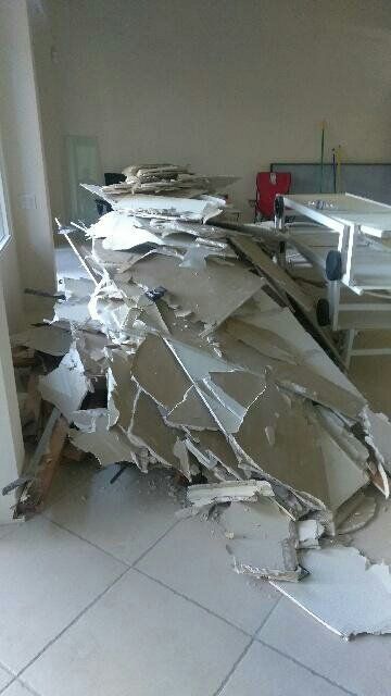 Pile of shattered debris on tile floor inside a building.