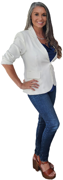 Woman in white jacket and jeans smiles, hand on hip, standing outdoors, medium heels.