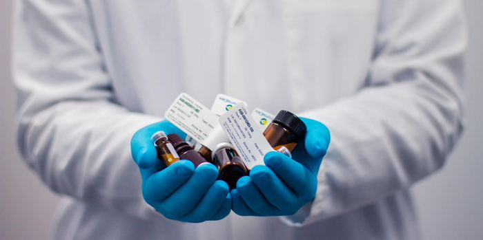 Pharmacist holding medication in hands