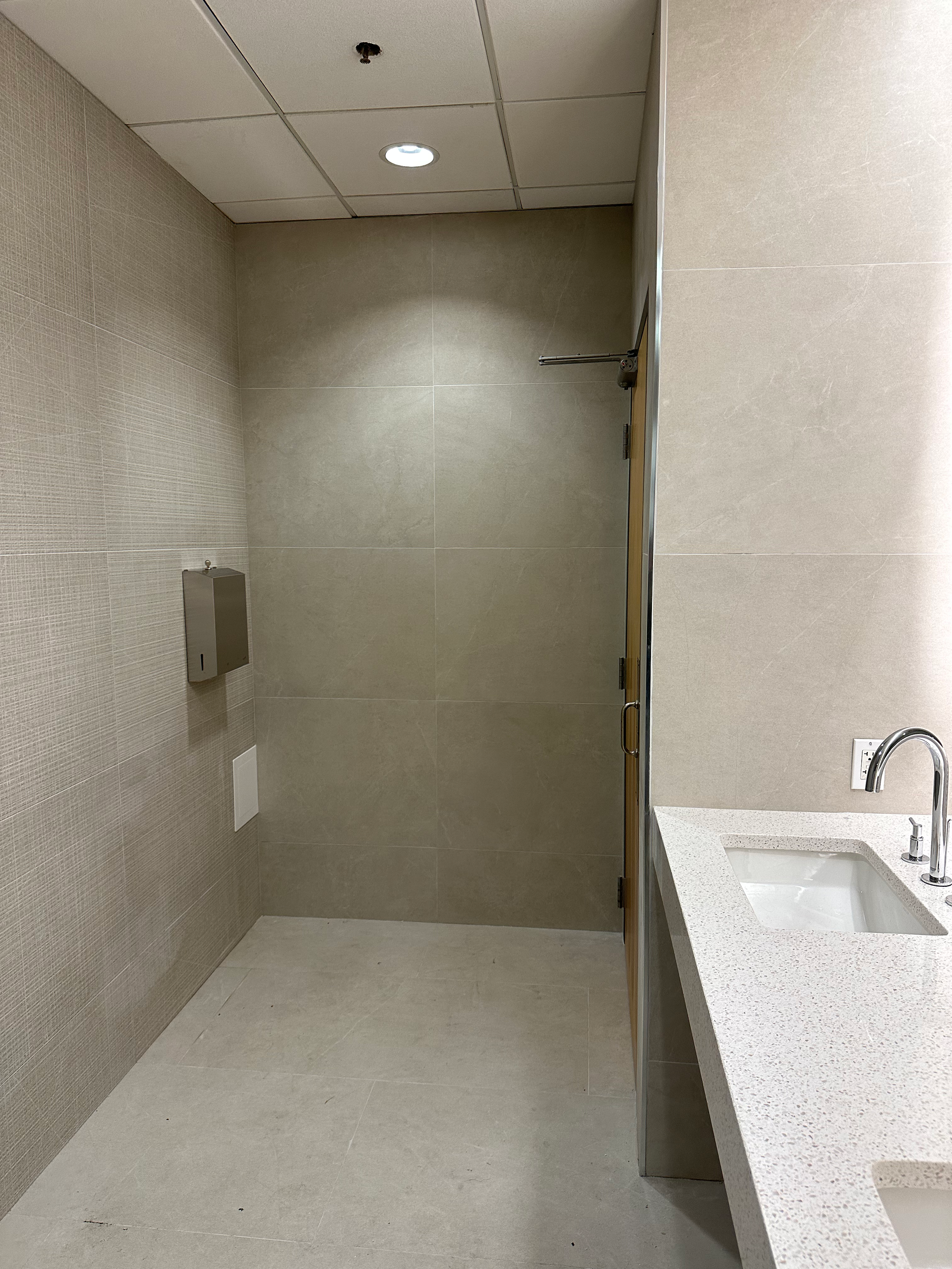 A bathroom with a sink and a walk in shower