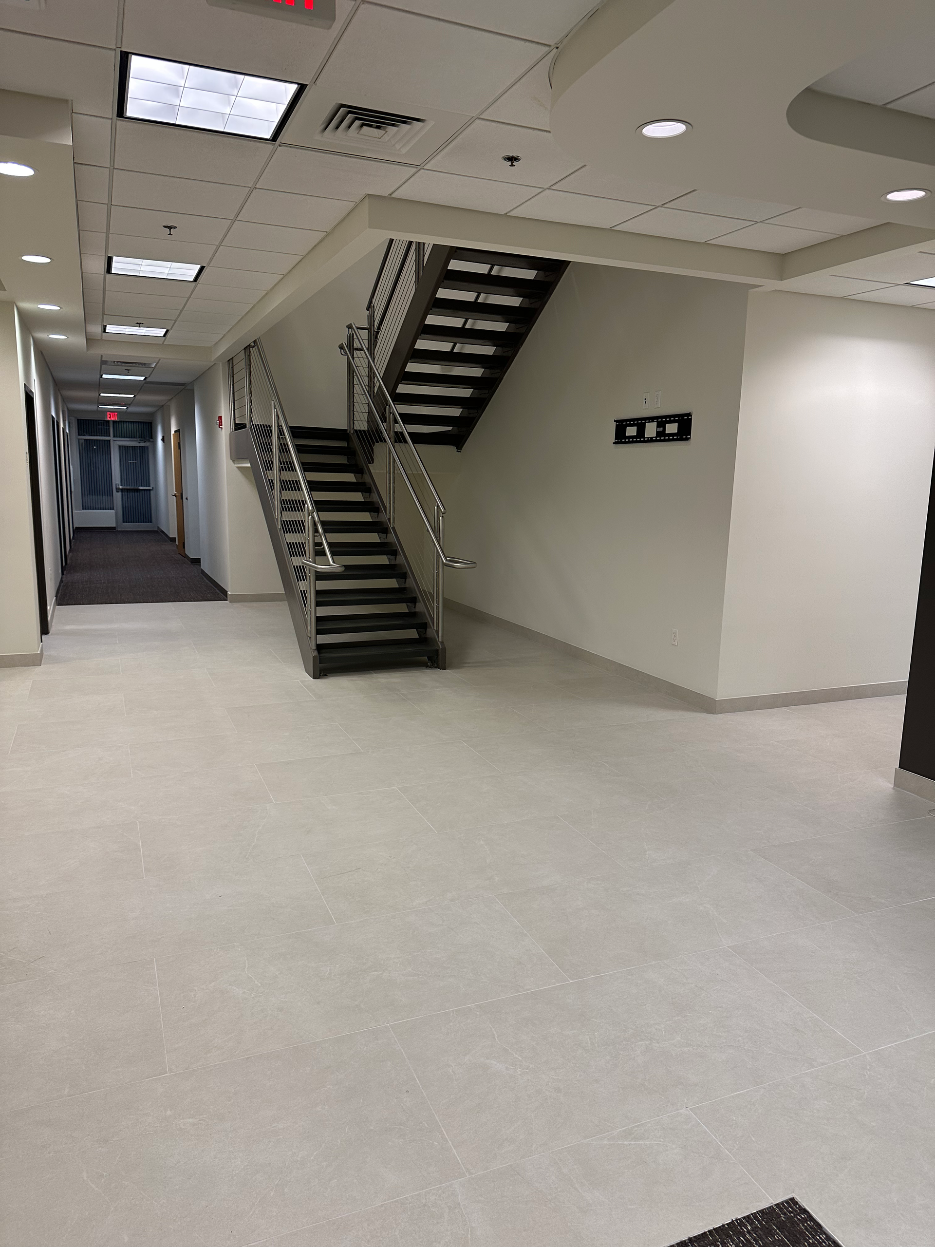 An empty hallway with stairs leading up to the second floor