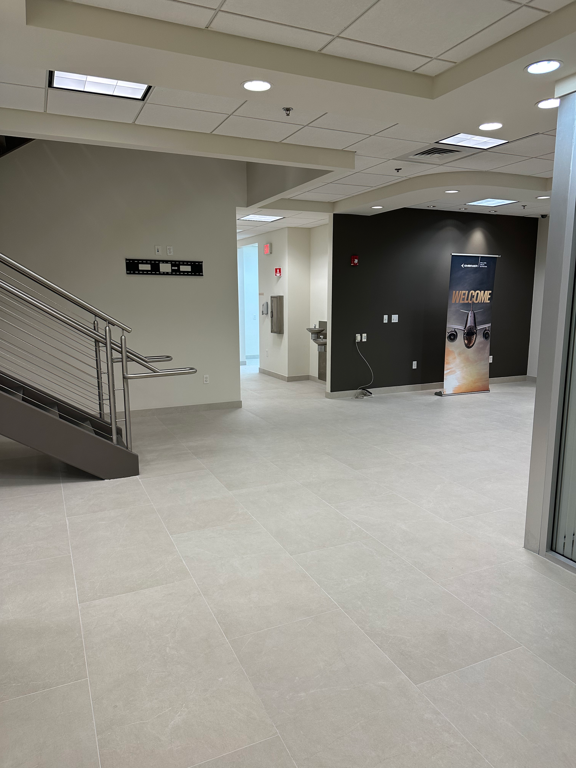 A hallway with stairs and a sign that says ' elevator ' on it