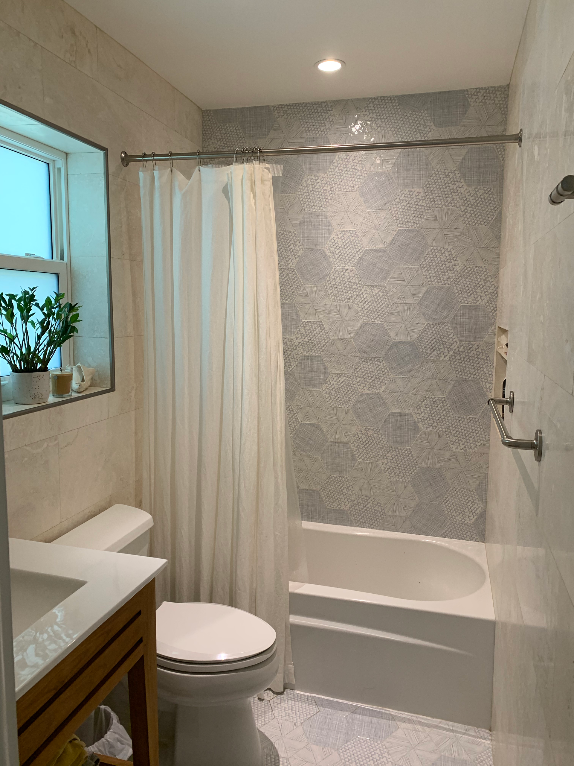 A bathroom with a toilet a sink and a bathtub