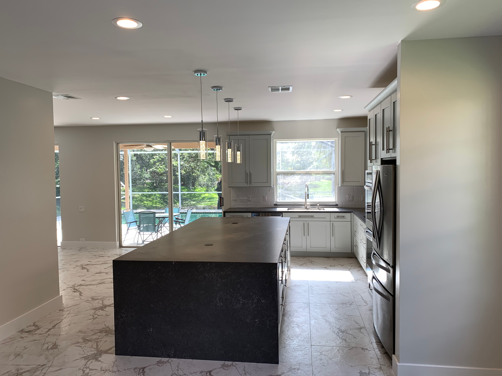 A kitchen with a large island and stainless steel appliances