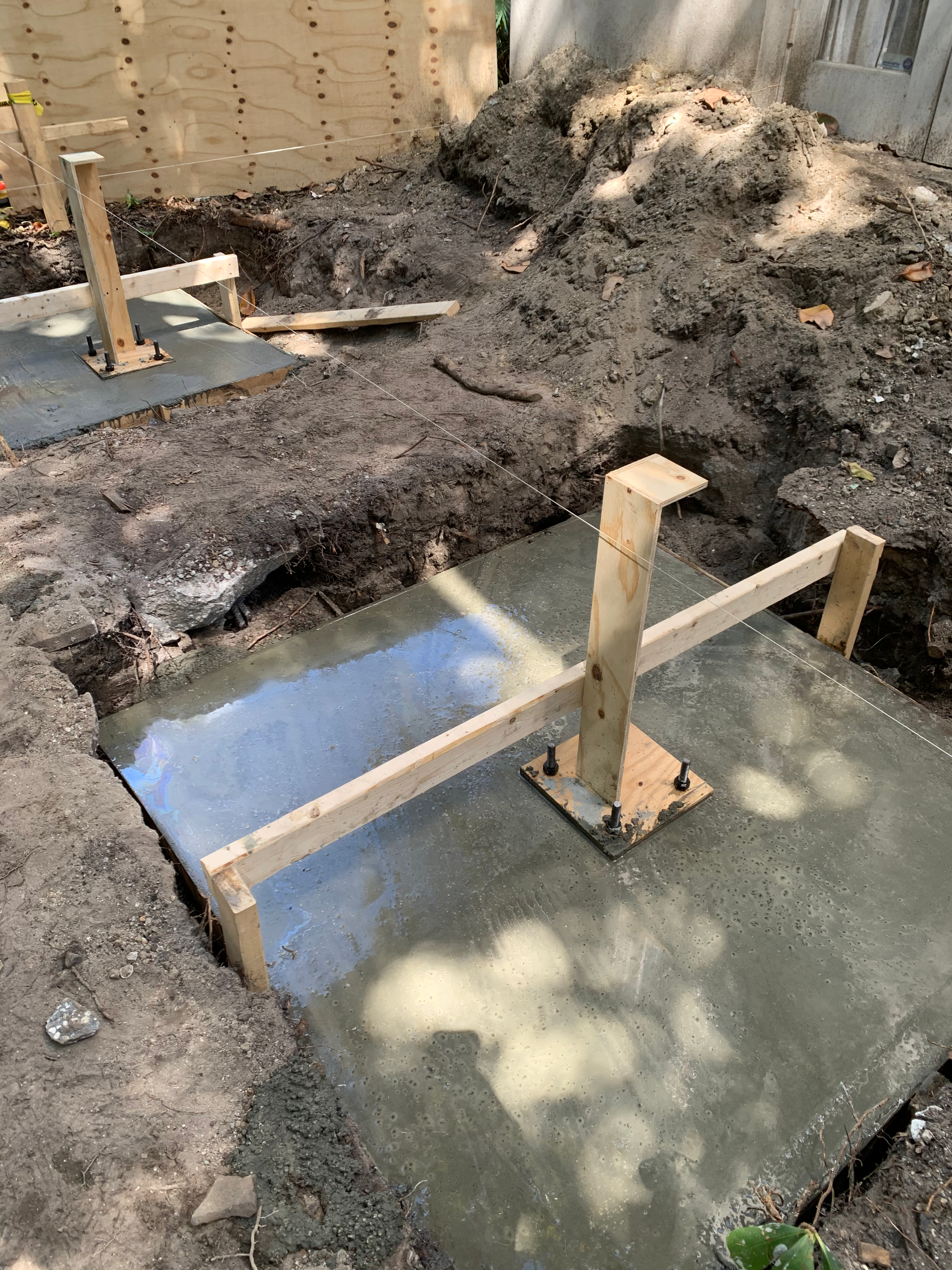 A wooden frame is sitting on top of a concrete base.