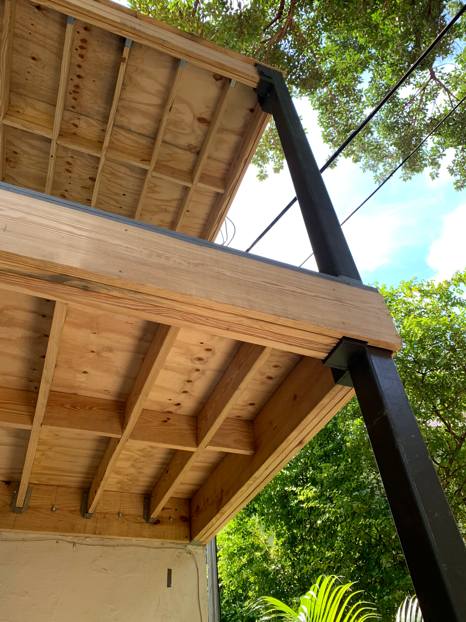 A wooden deck is being built on top of a building.