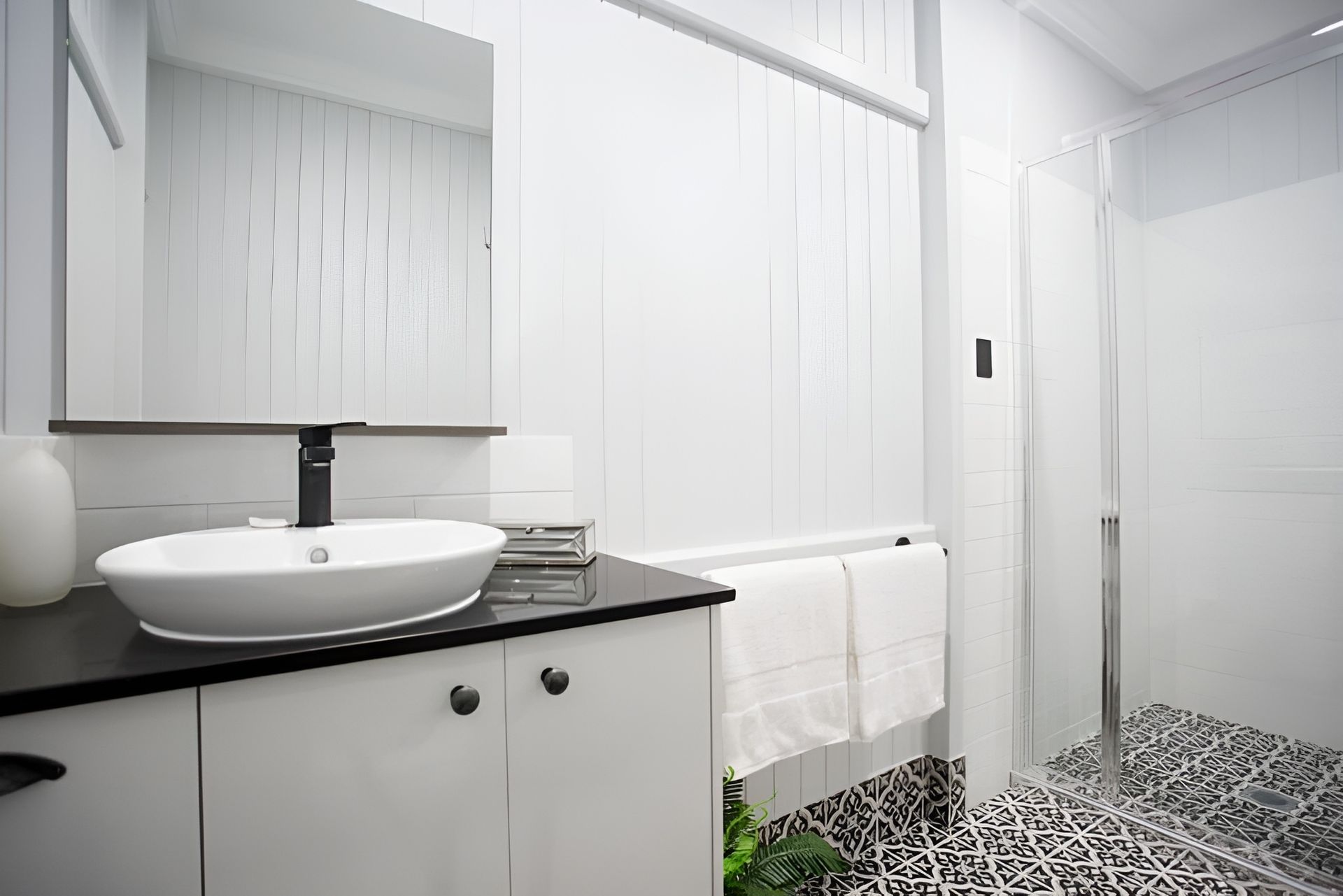 A Bathroom With a Sink, Mirror and Walk in Shower — Mackay Cabinetmaking Service In Glenella, QLD