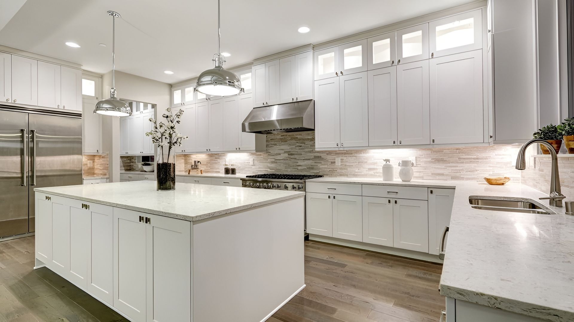 A Kitchen With White Cabinets, Stainless Steel Appliances, and a Large Island — Mackay Cabinetmaking Service In Glenella, QLD