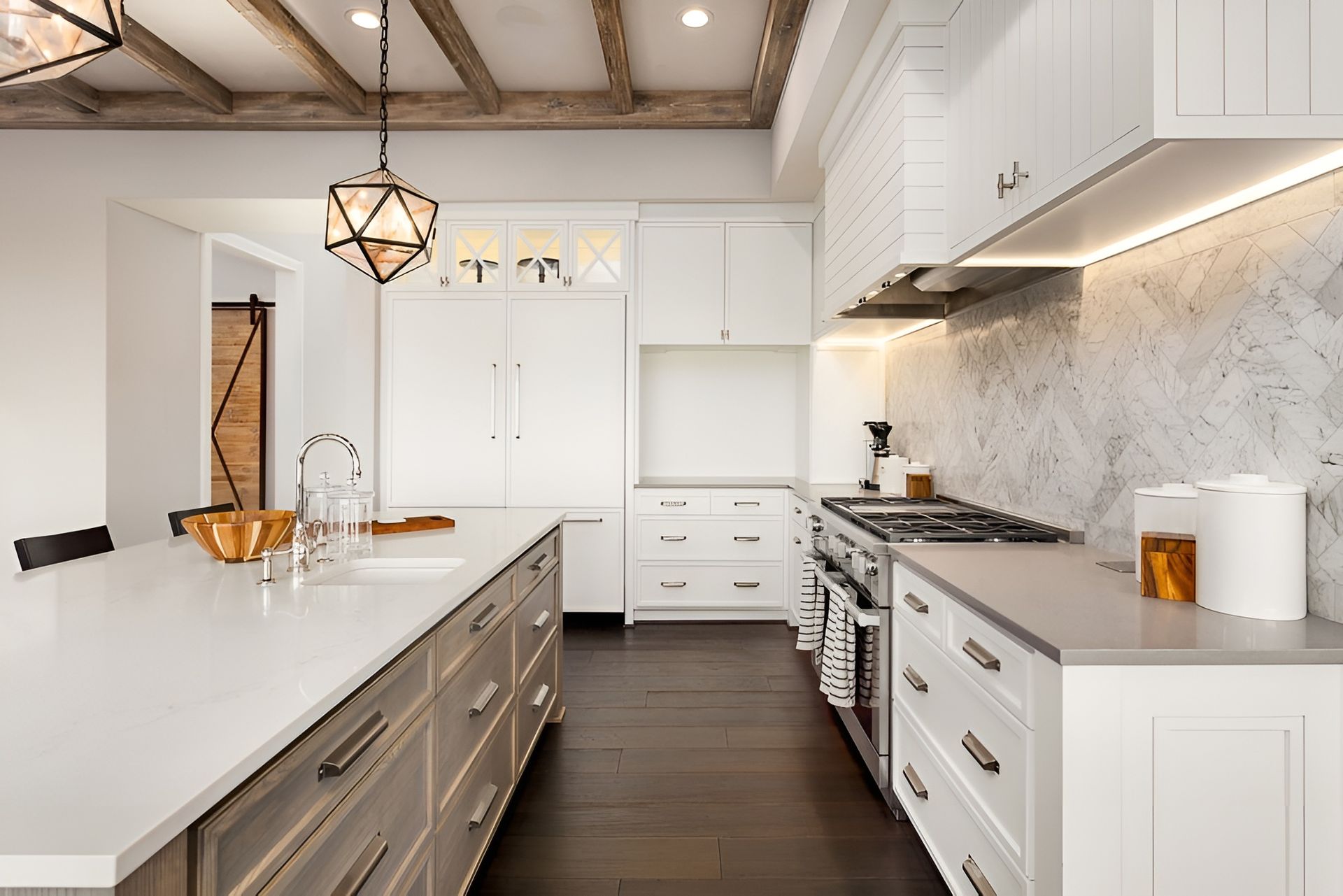 A Kitchen With White Cabinets and Stainless Steel Appliances — Mackay Cabinetmaking Service In Glenella, QLD