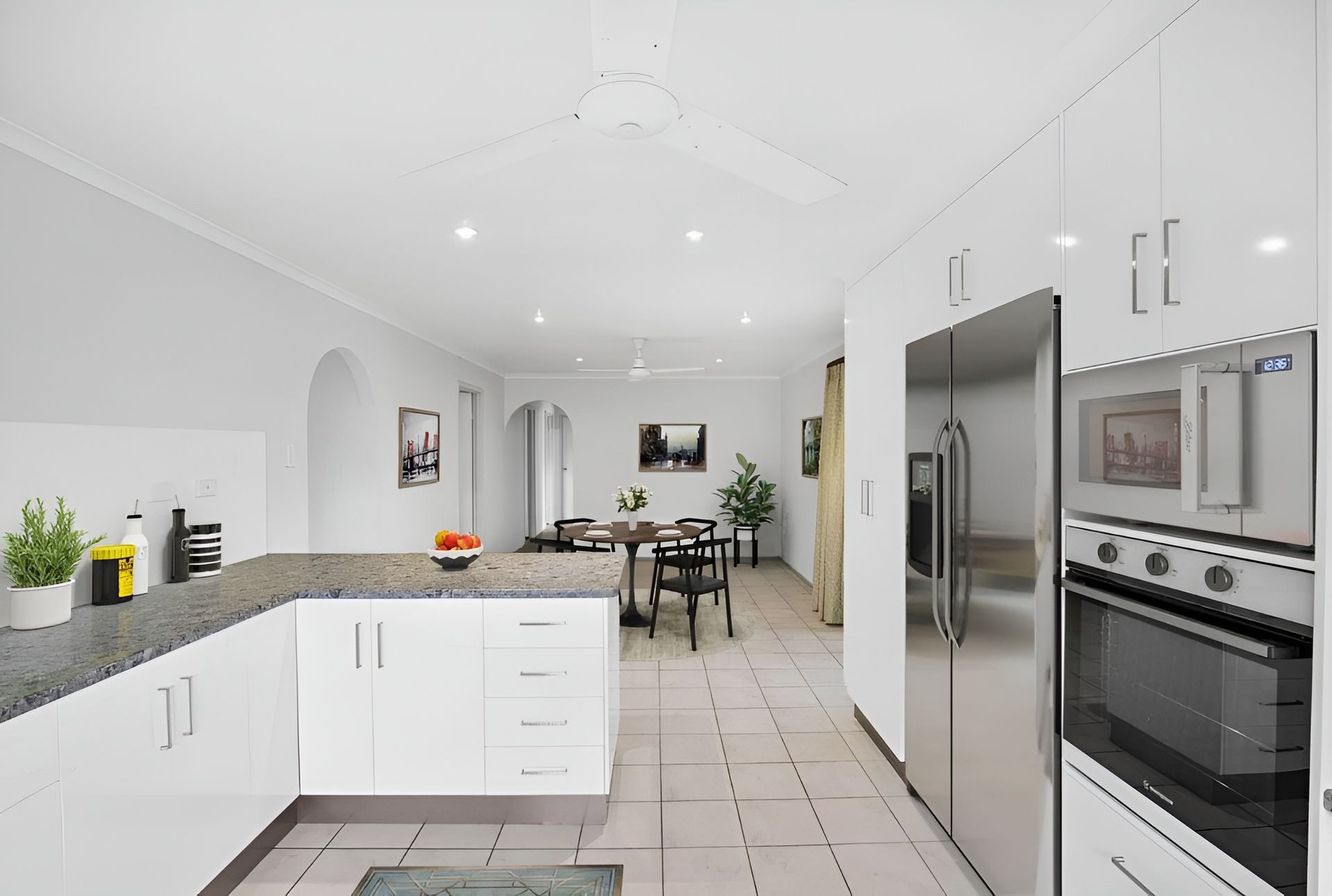 A Kitchen With White Cabinets and Stainless Steel Appliances — Mackay Cabinetmaking Service In Glenella, QLD