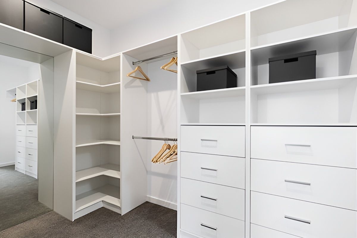 A Walk in Closet With Lots of Shelves and Drawers — Mackay Cabinetmaking Service In Glenella, QLD