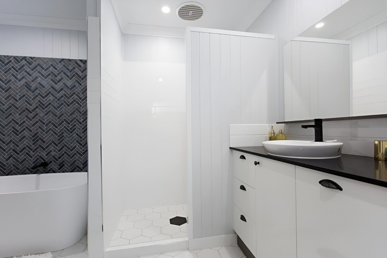 A Bathroom With a Sink, Mirror and Shower — Mackay Cabinetmaking Service In Glenella, QLD