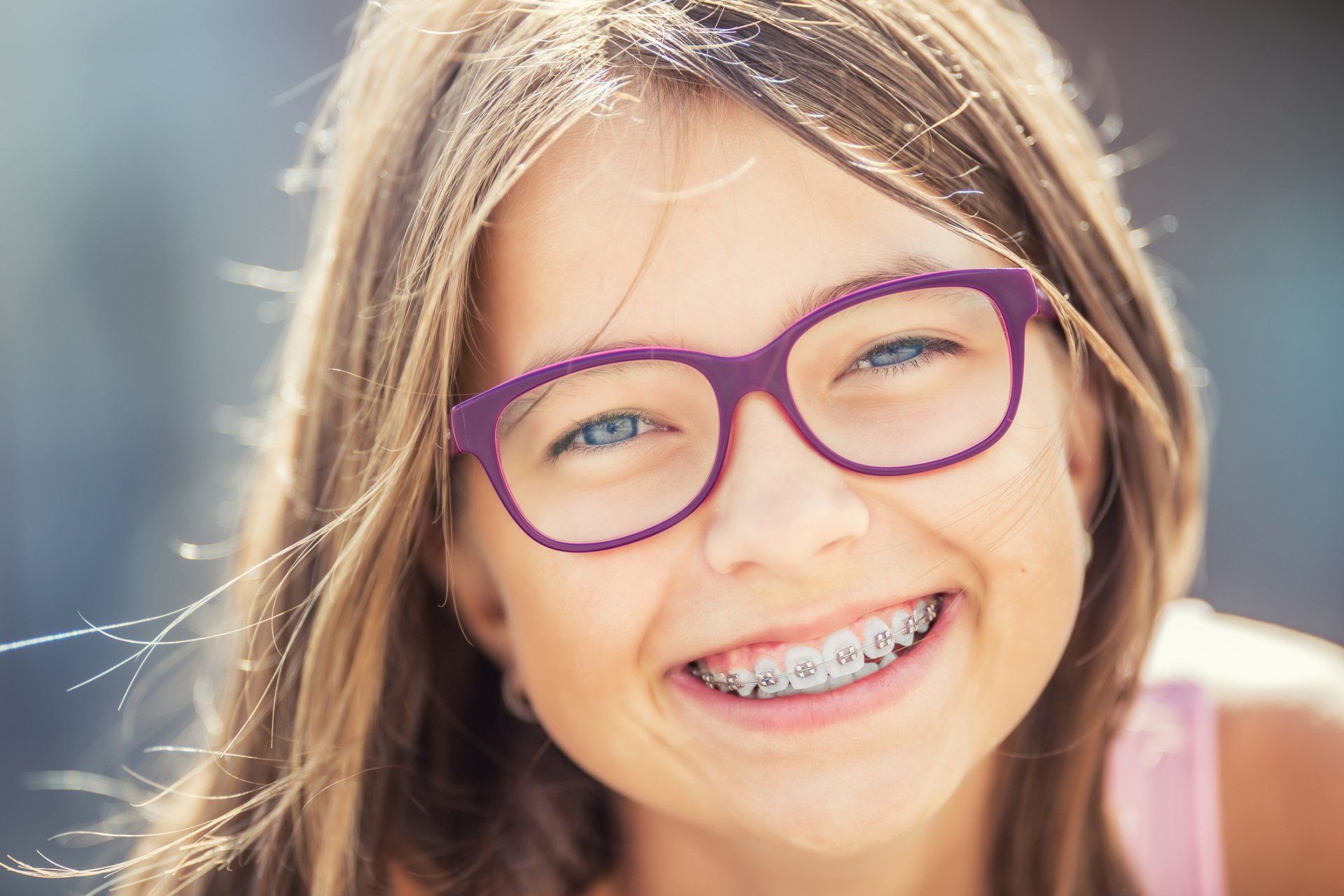 Teeth Cleaning — Smiling Kid Wearing Violet Glasses in Hampton, VA