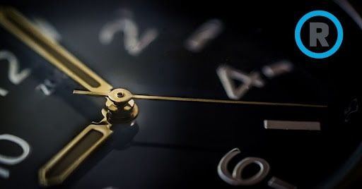 A close up of a watch face with the letter r on it