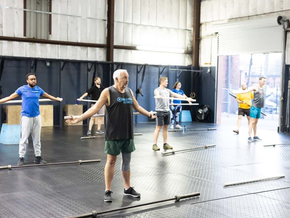 A group of people are doing exercises in a gym.