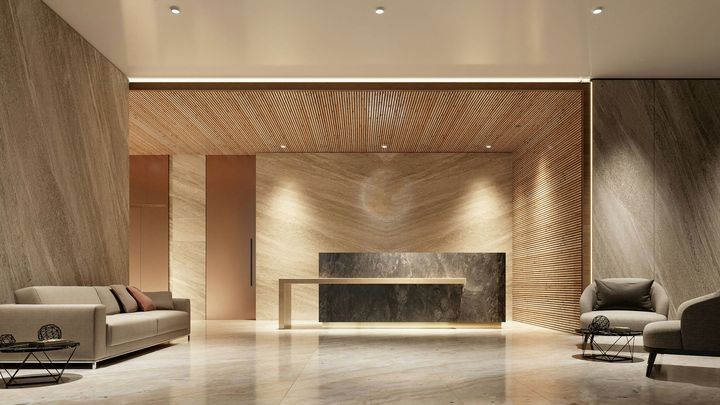 Elegant lobby with stone walls, decorative wood paneling, seating, and a reception desk.