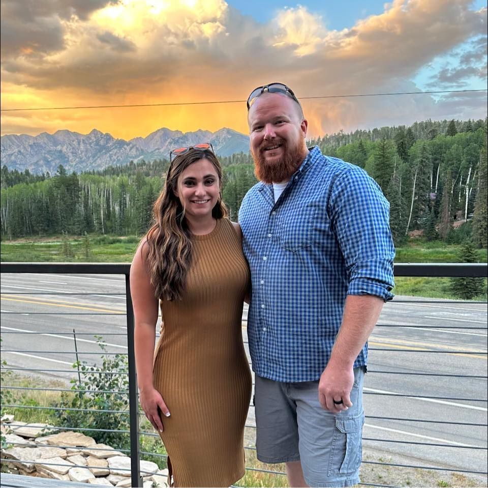 A for sale sign with a house in the background