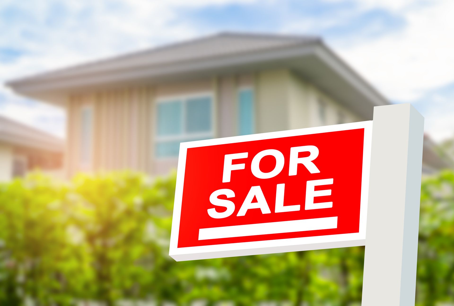 A for sale sign in front of a house.