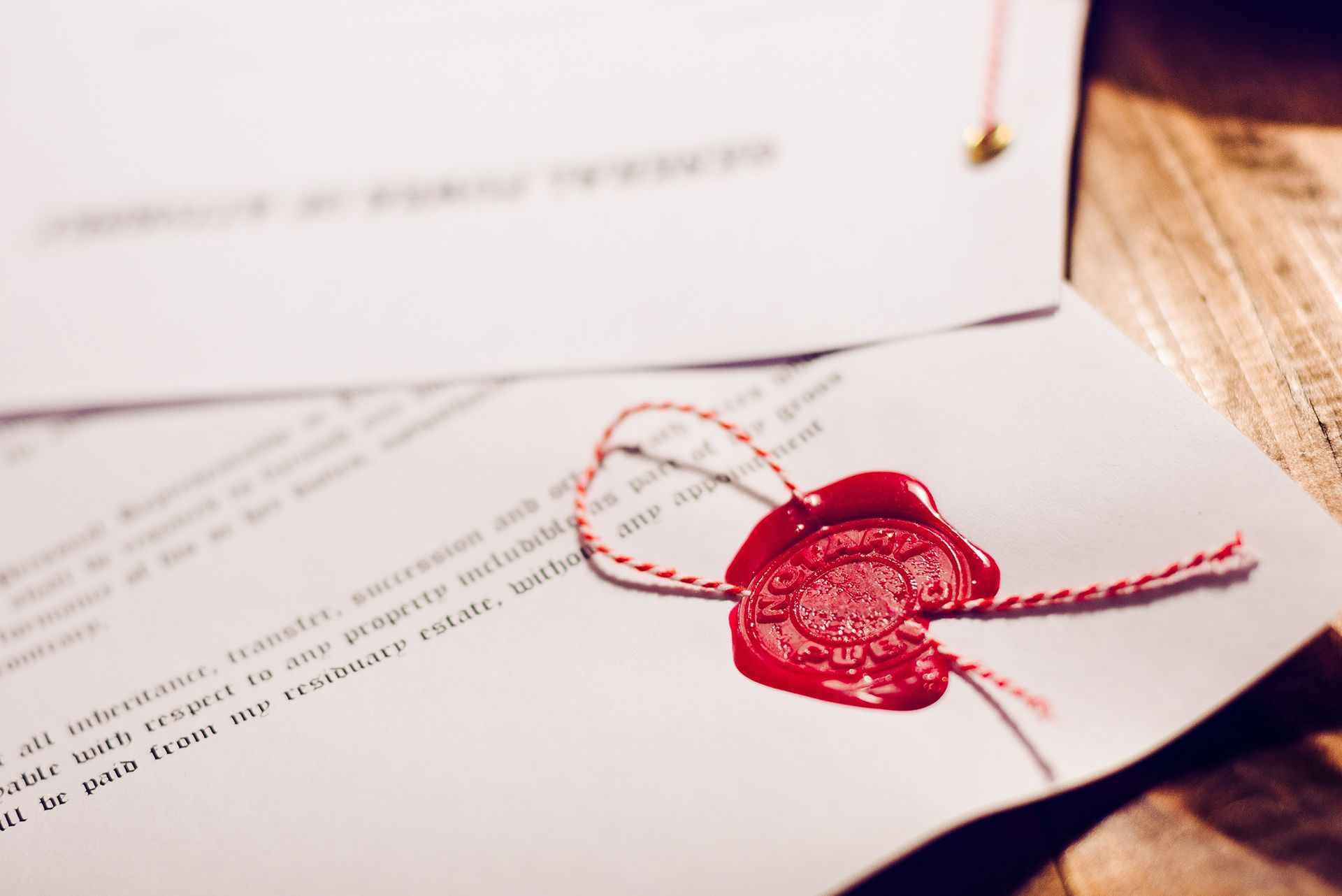 A piece of paper with a red wax seal on it.