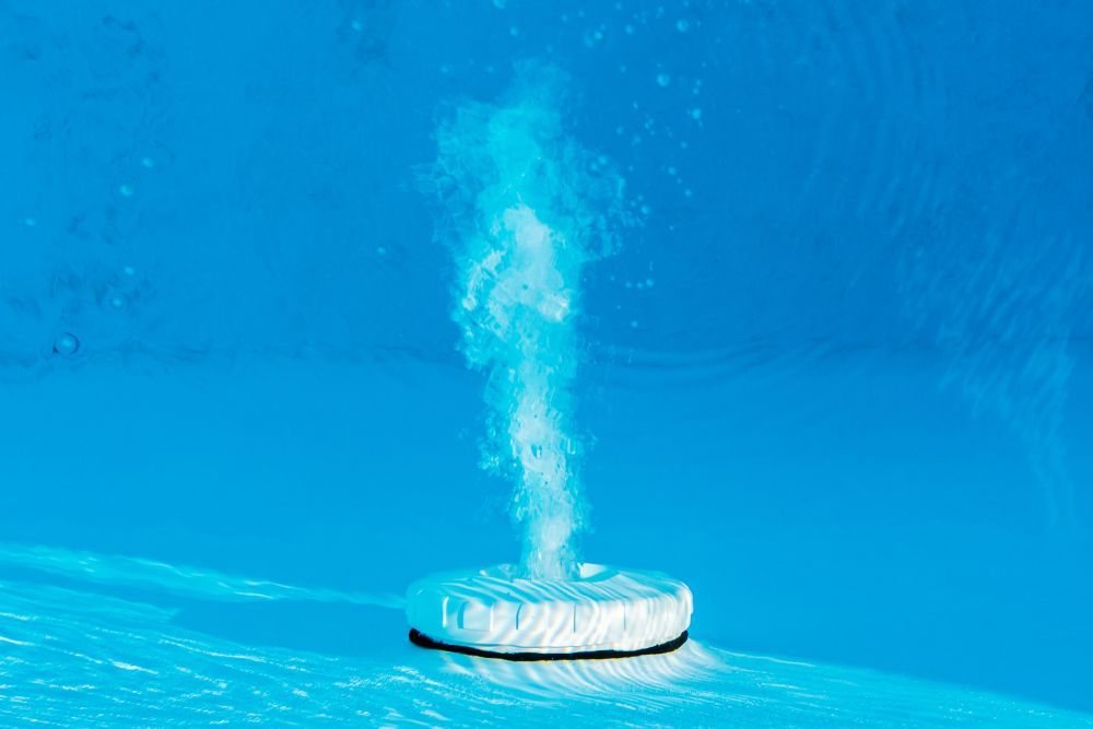 A White Circular Device Emitting Bubbles in Blue Water — Port Douglas Pool Shop in Cape Tribulation, QLD
